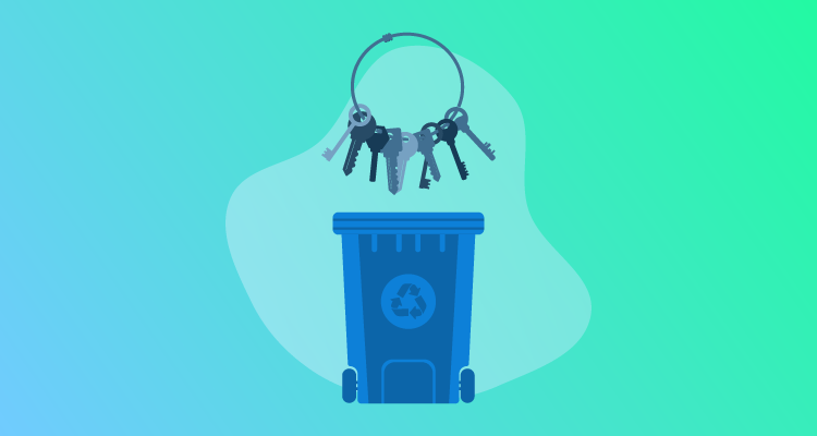Keys on a keychain above a recycling bin.